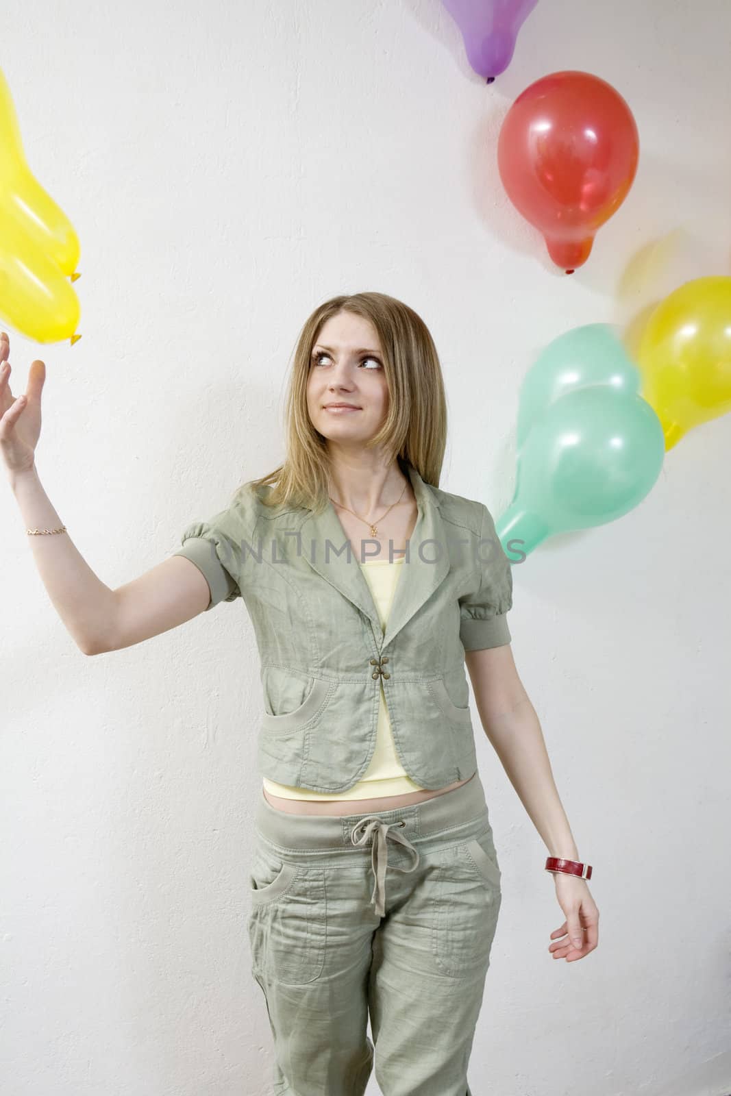 attractive woman doing exercise with balloon in gym by elenarostunova