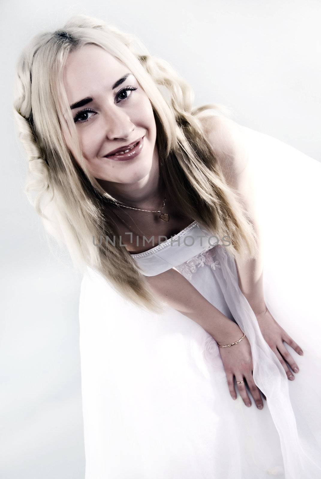 Young beautiful smiling  bride  with blond hair posing