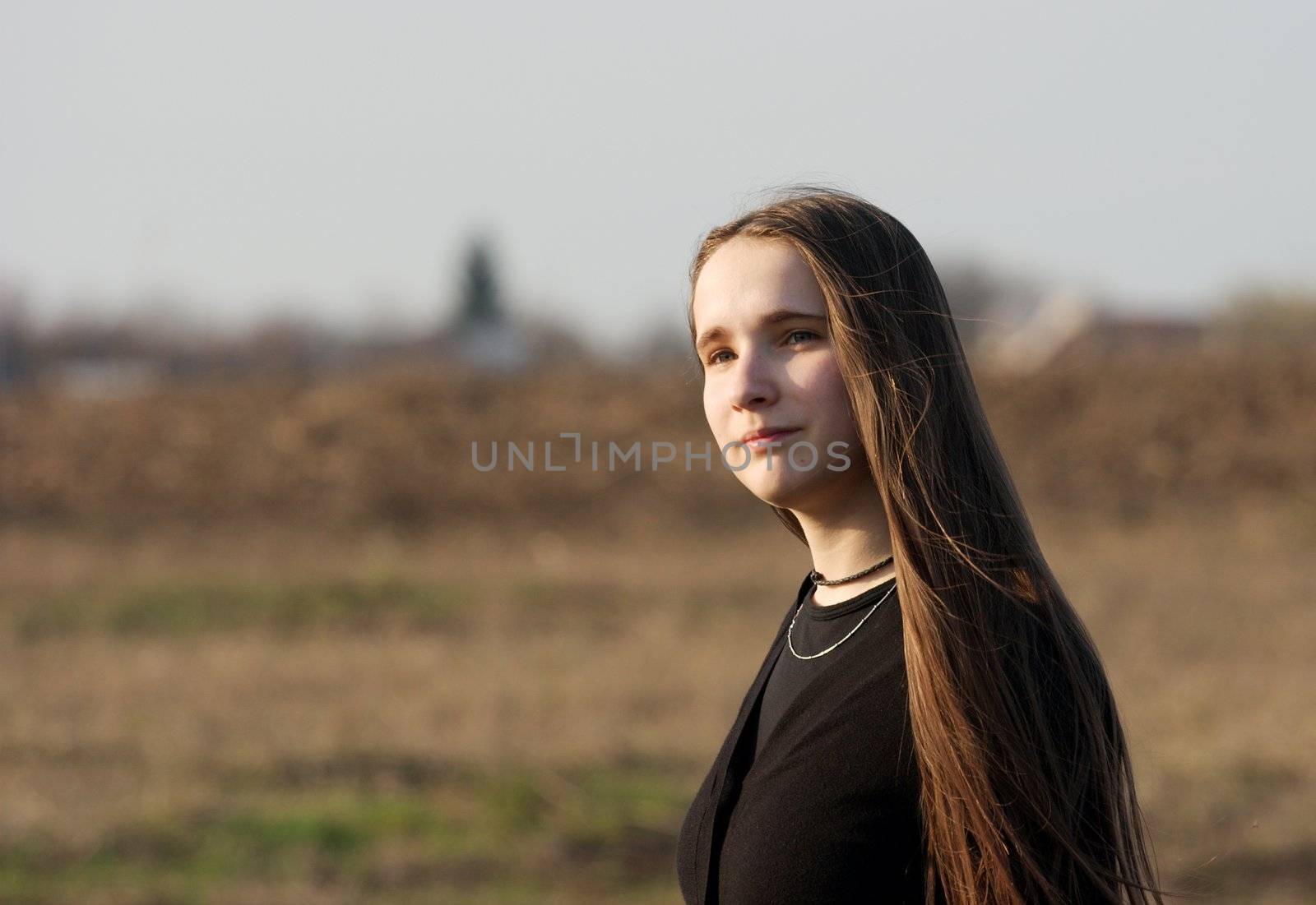 Portrait of girl walking on a dry field