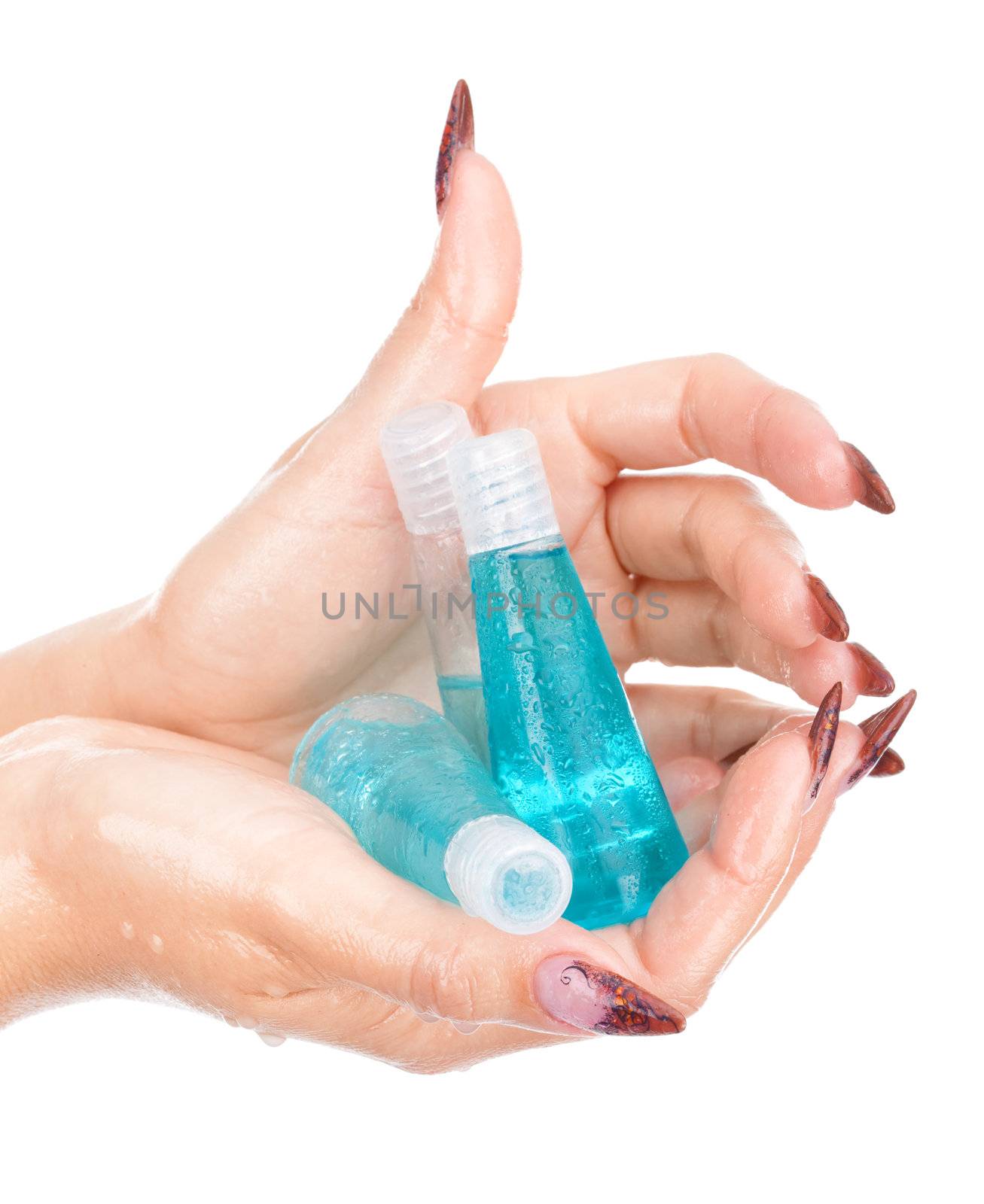 Beautiful wet hands holding bottles with shampoo on isolated white background