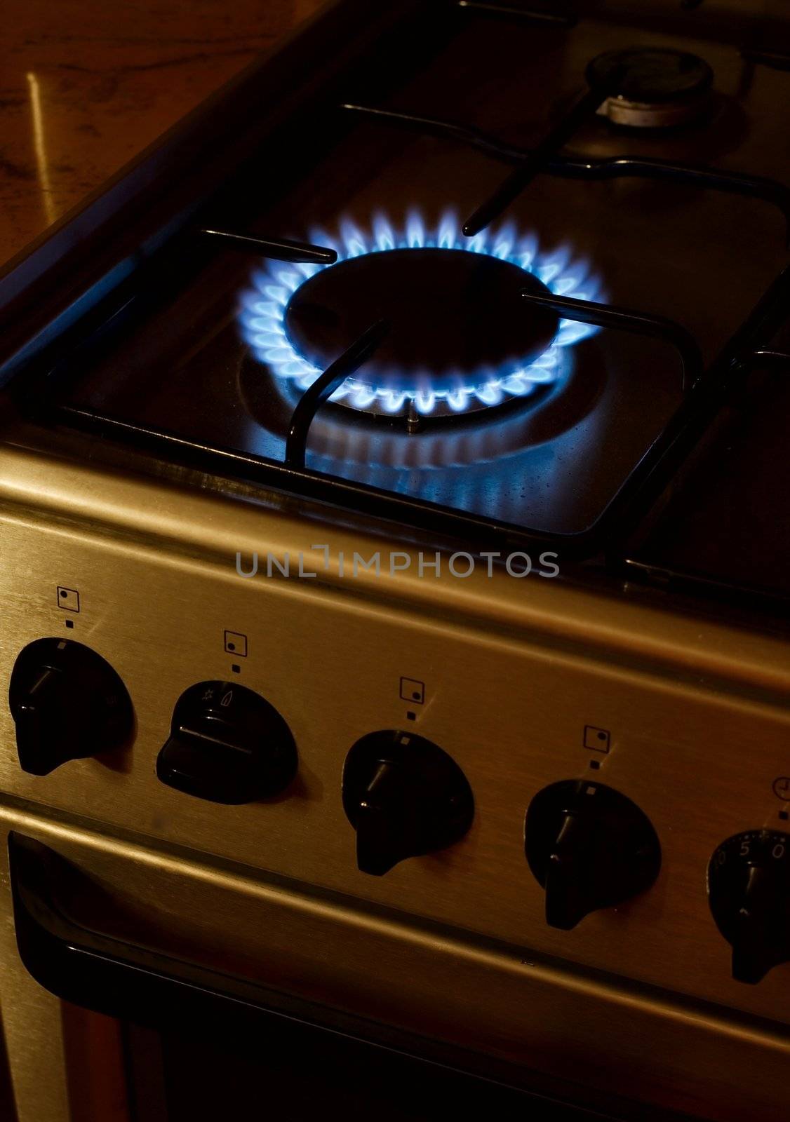 Gas burner of a stove glowing in the evening