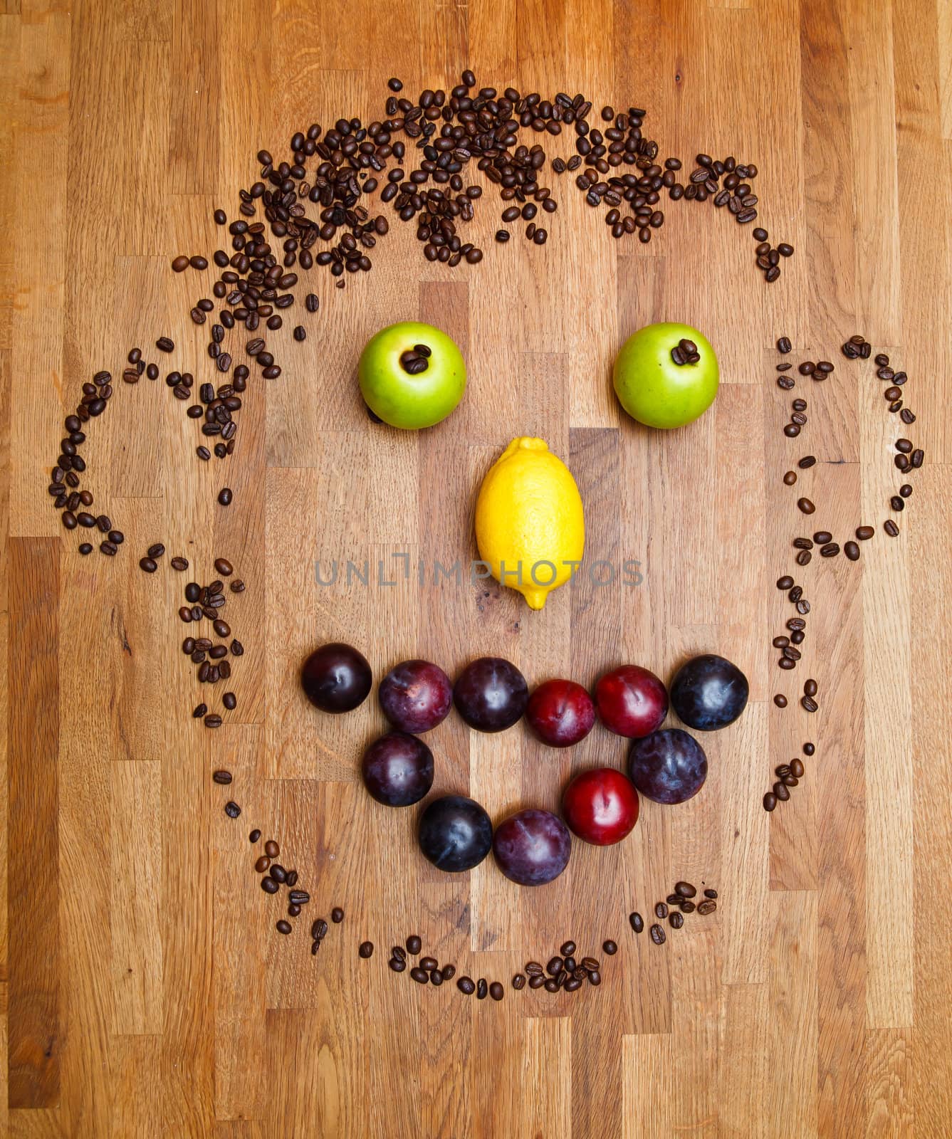 face made of fruits on wooden background