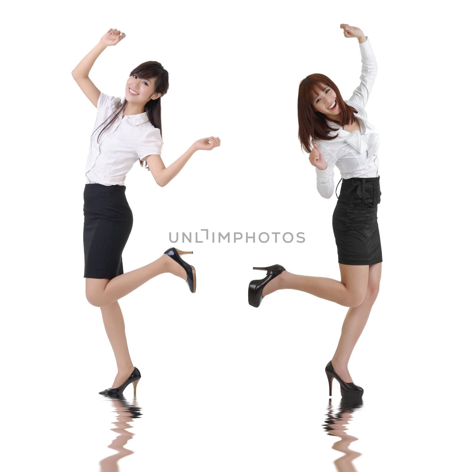 Happy business women dancing over white background.