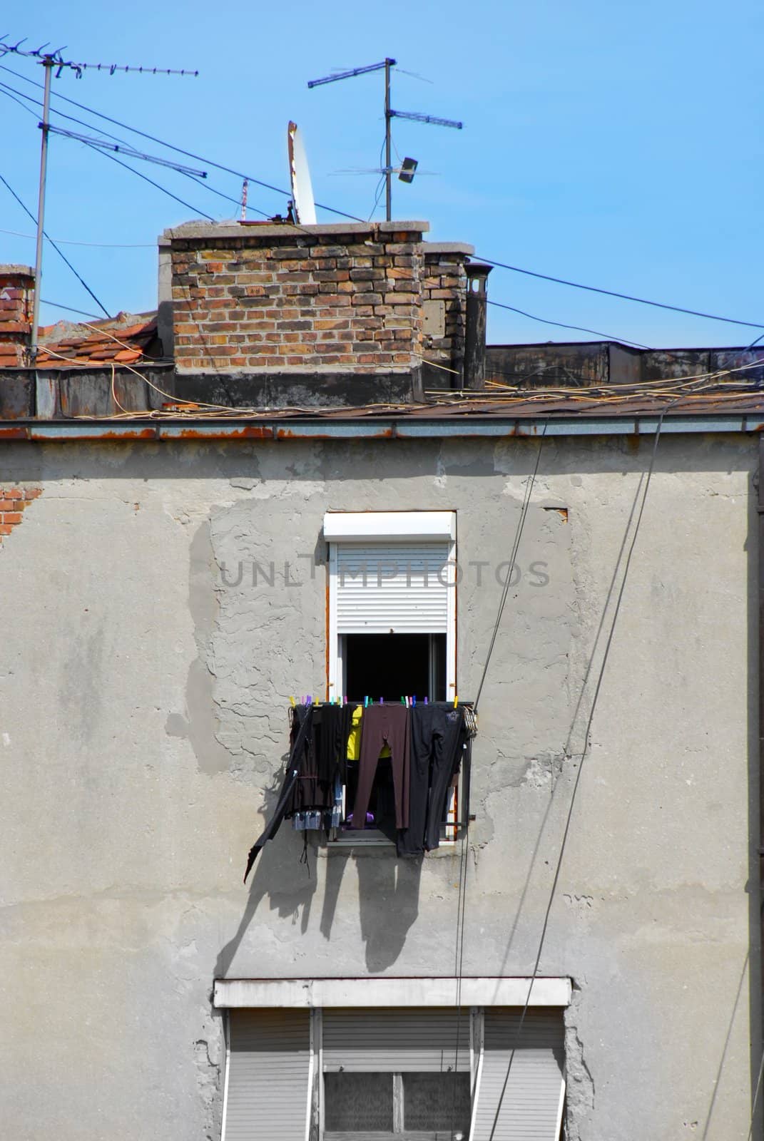 drying laundry on string outdoor below window