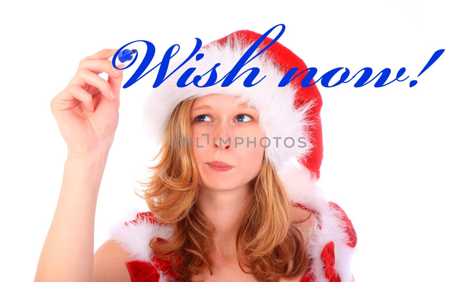 a young woman is using a blue felt-tip marker to write the words "Wish now!" on an imaginary wall