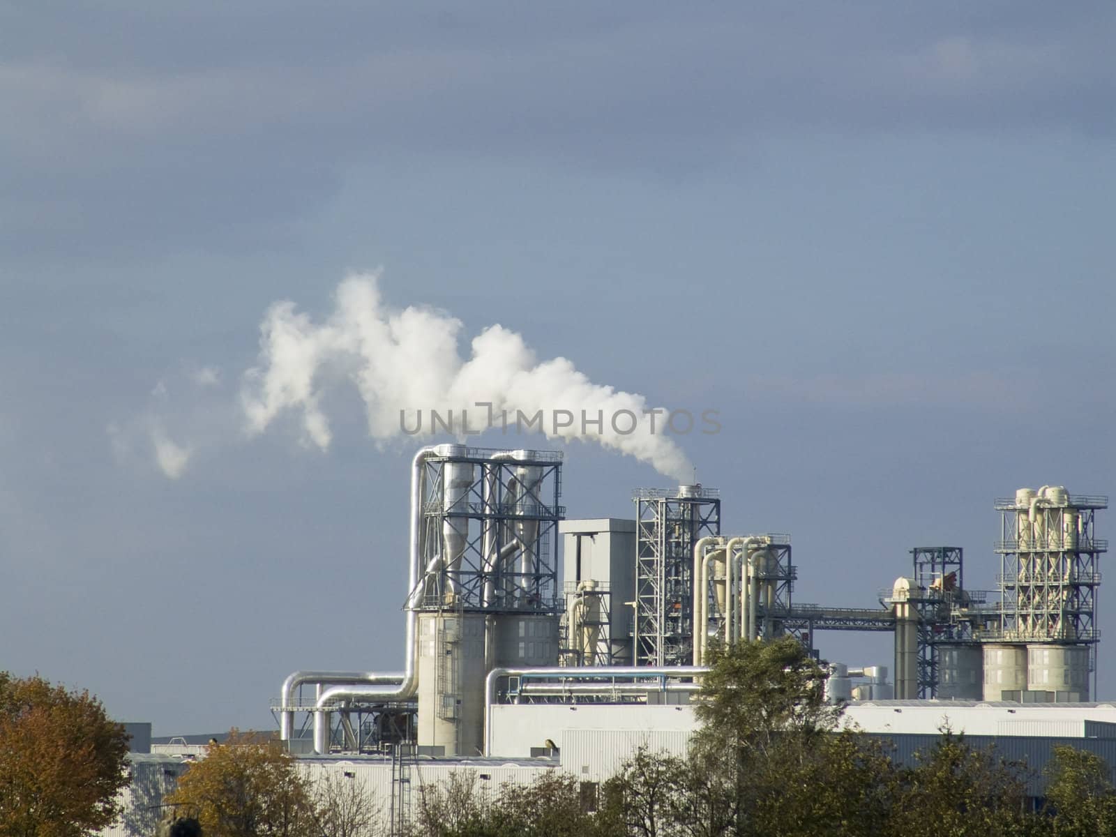 Ecological pollution by a white smoke from a factory pipe 