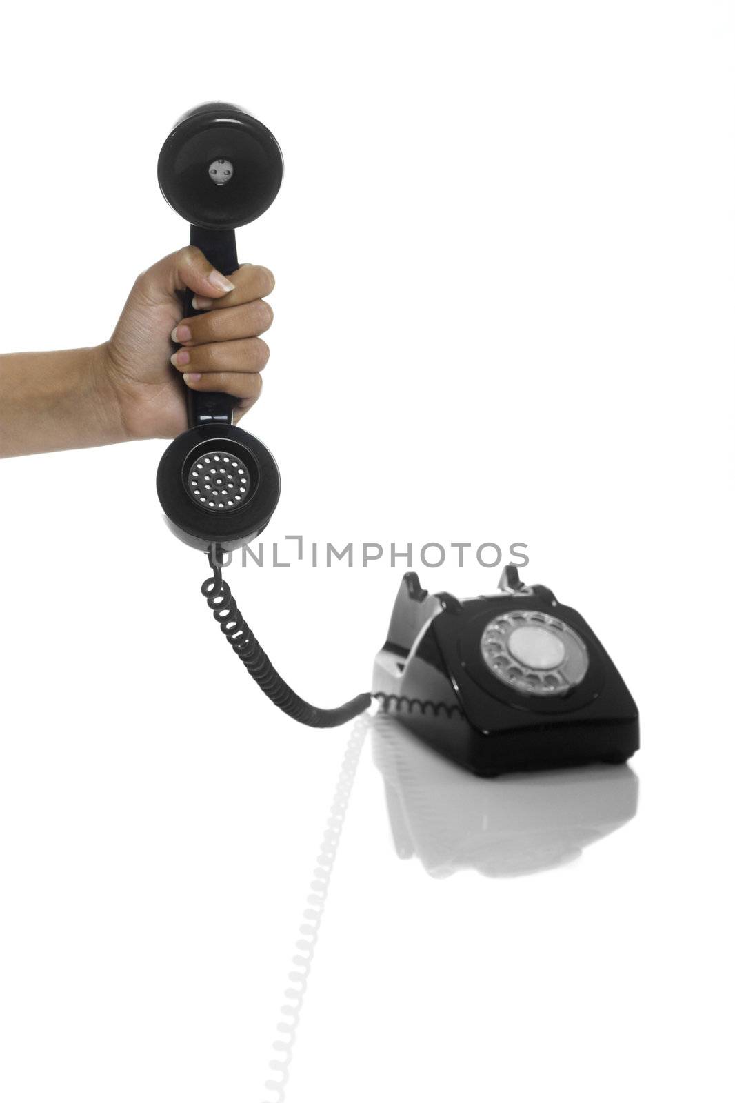 Male hand holding an hold vintage phone