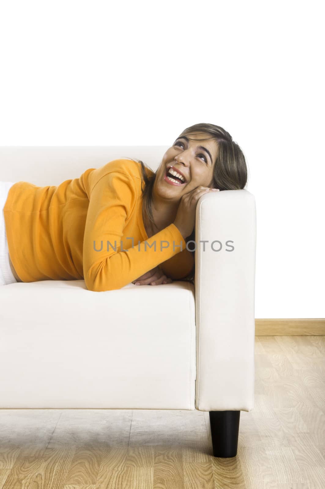 Beautiful woman laughing on the couch at home