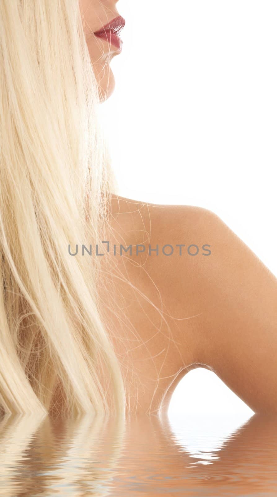 hair and lips of lovely blonde standing in water