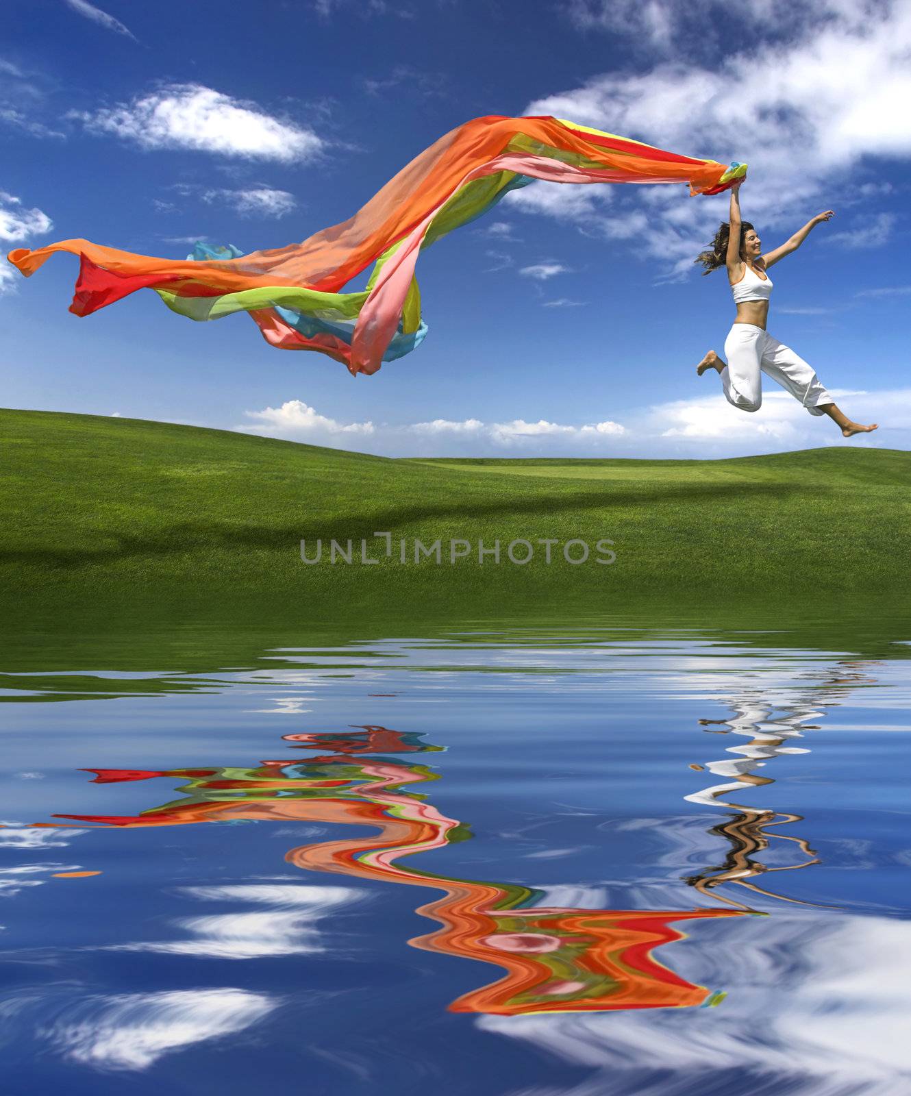 Young beautiful woman jumping with a scarf (reflection made in PS)