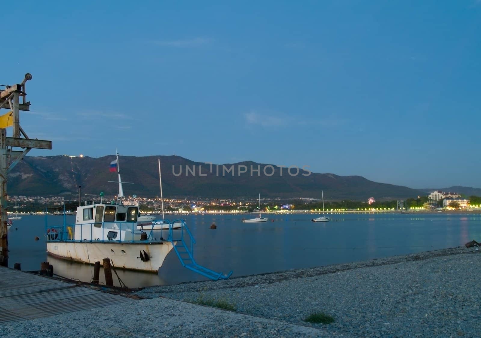 fisherman's boat in the harbour in a small town on the beach. Night view