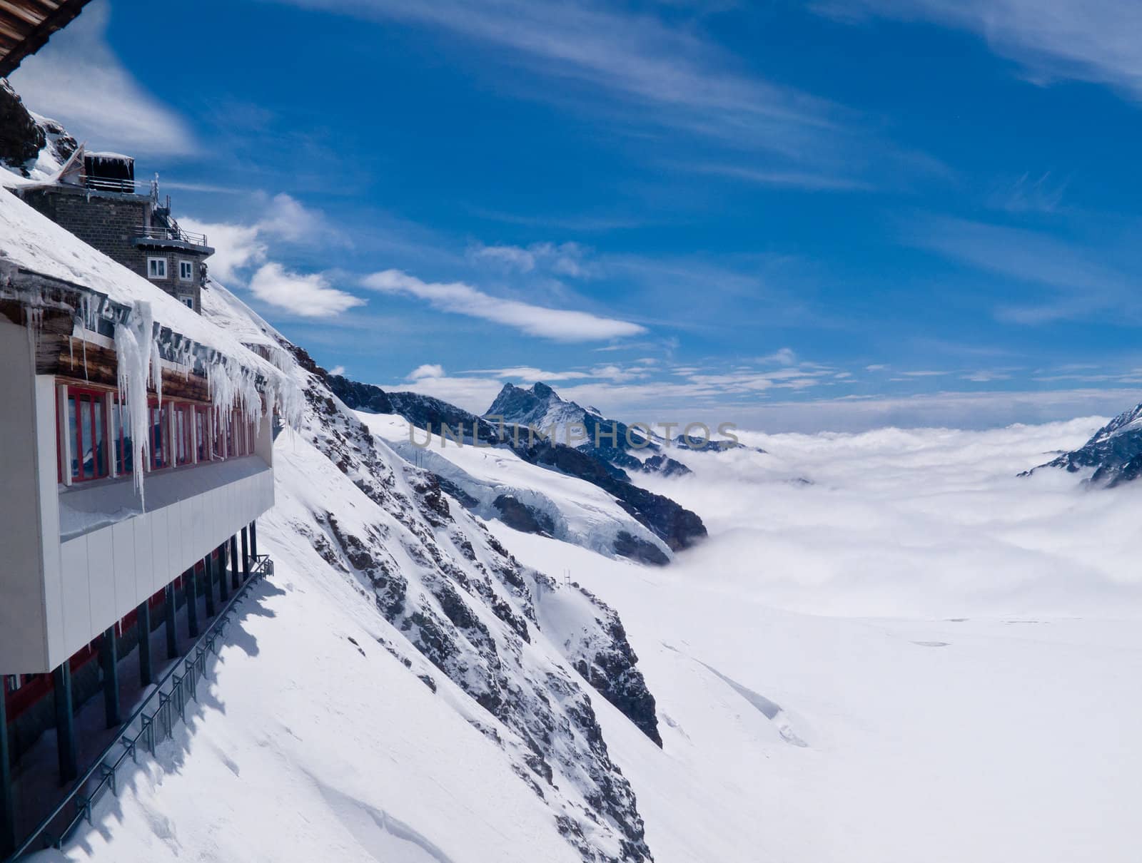 Jungfraujoch in Swiss Alps showing station and distant peaks above clouds