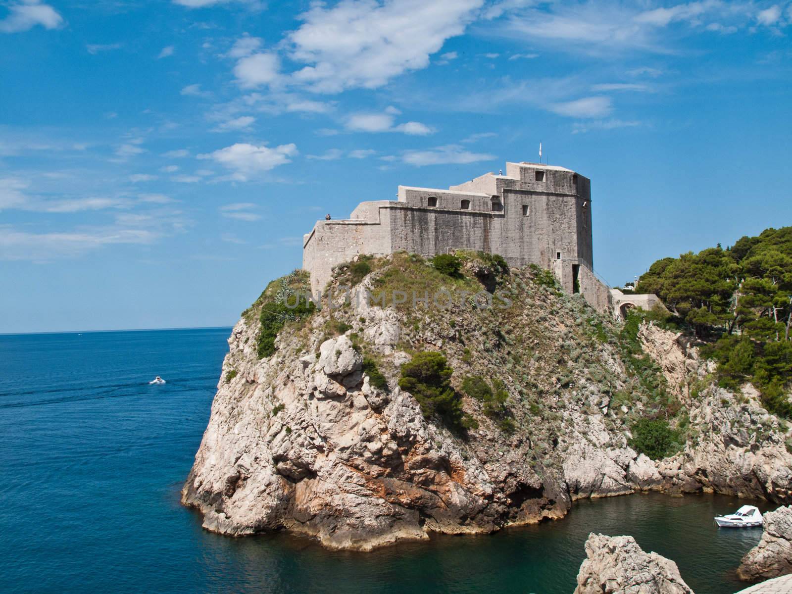 Ancient fortress on the cliff edge of Dubrovnik protects the port