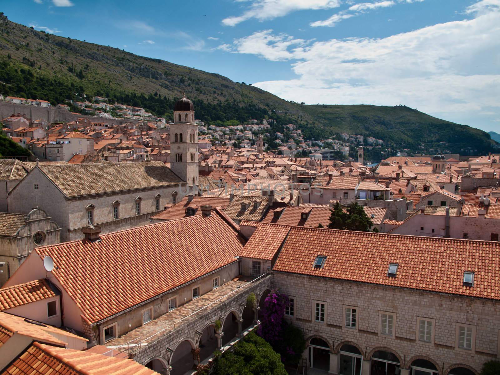 View over rooftops of Dubrovnik to tower and distant ocean