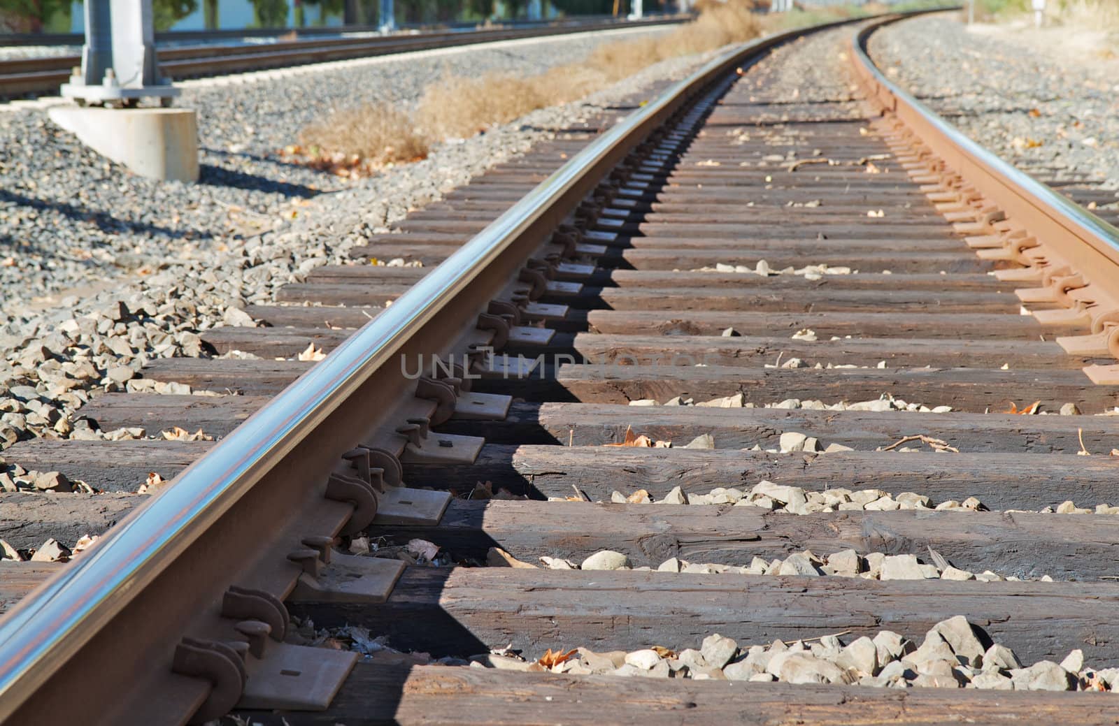 Close up of curved railroad track disappearing in the distance