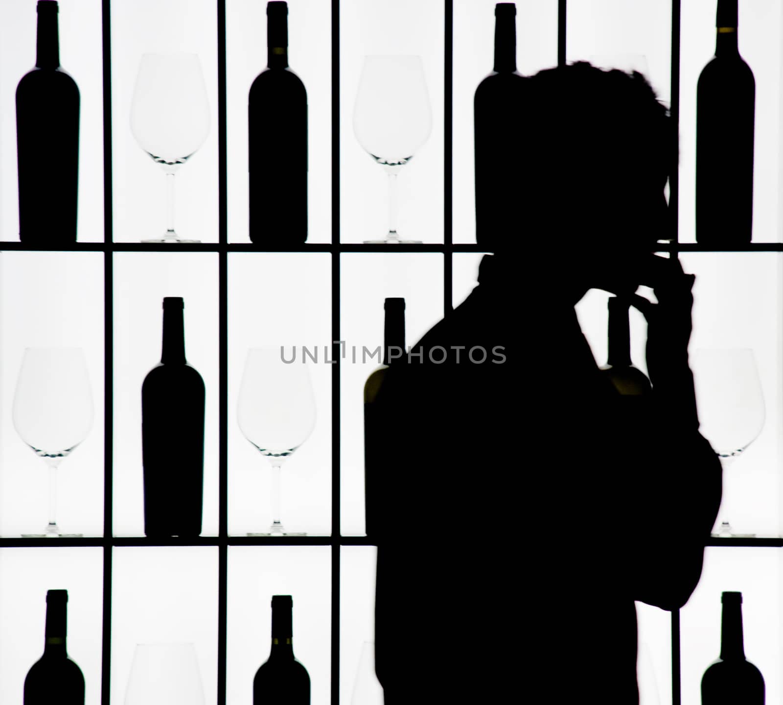Silouette of a waiter against bottle and glasses