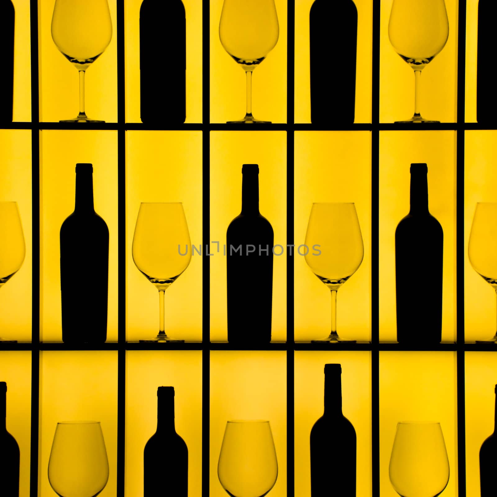 Black bottles and crystal glasses with a yellow backlight