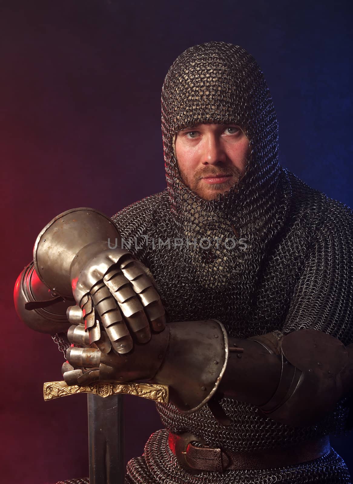 The soldier in a medieval knightly armour with we throw in hands