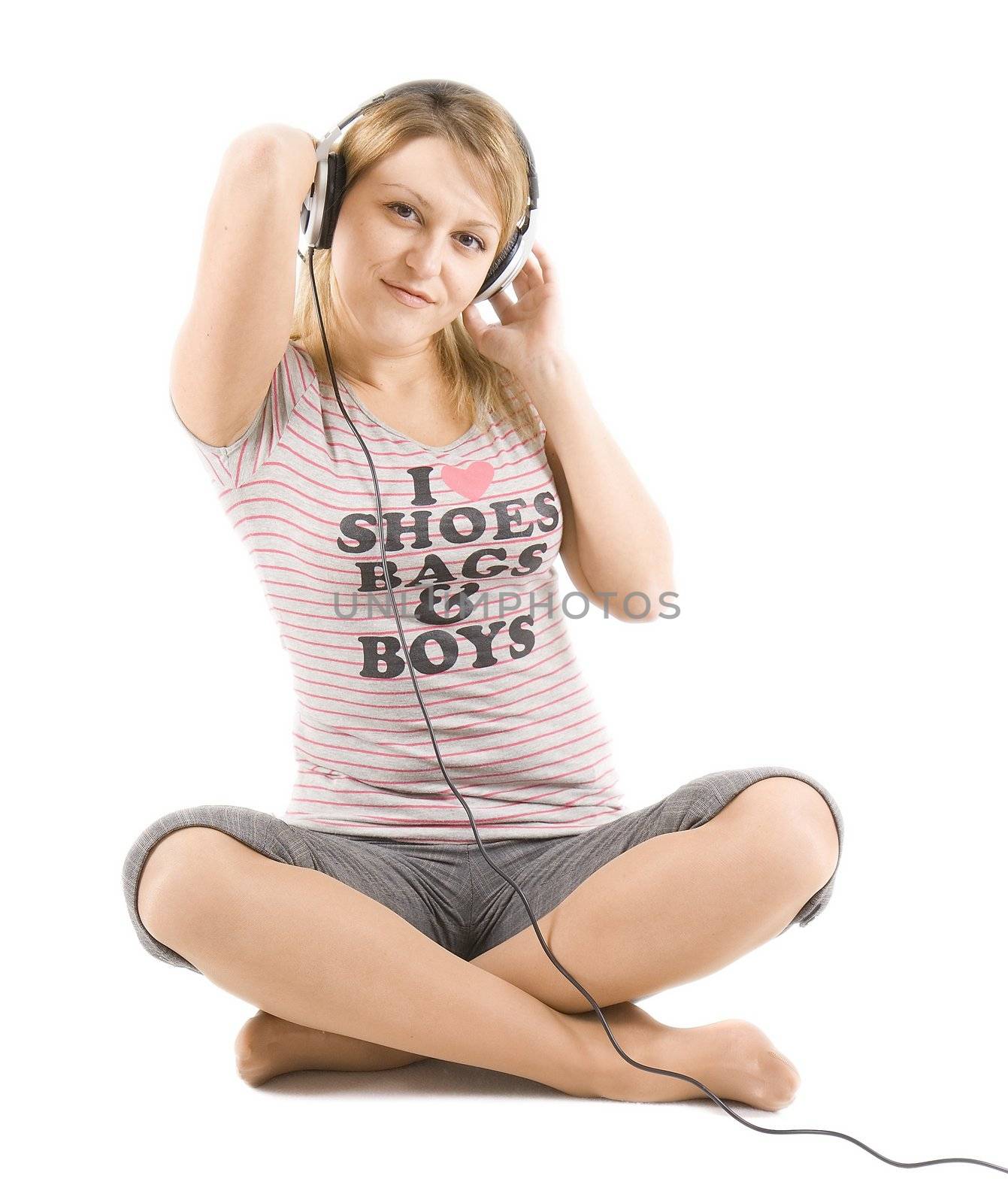 The girl sits on floor and with pleasure listens to music