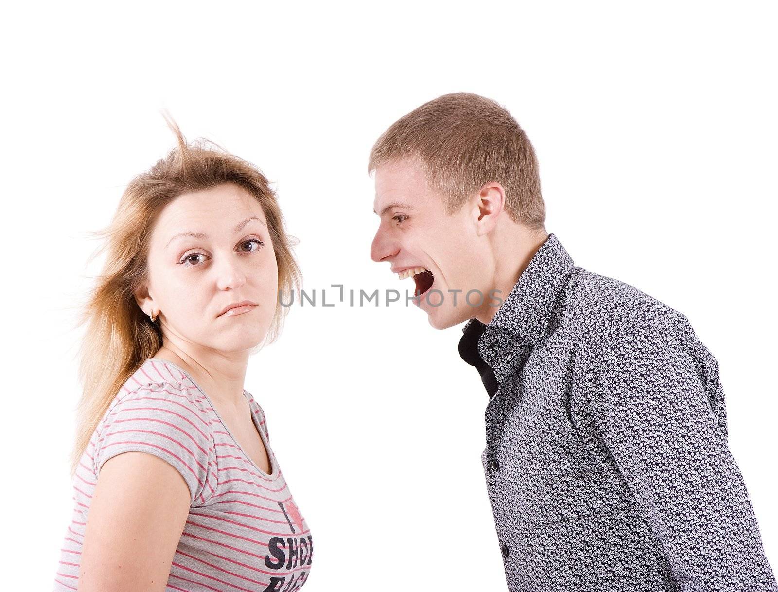 On white background the young man strongly shouts at the young woman