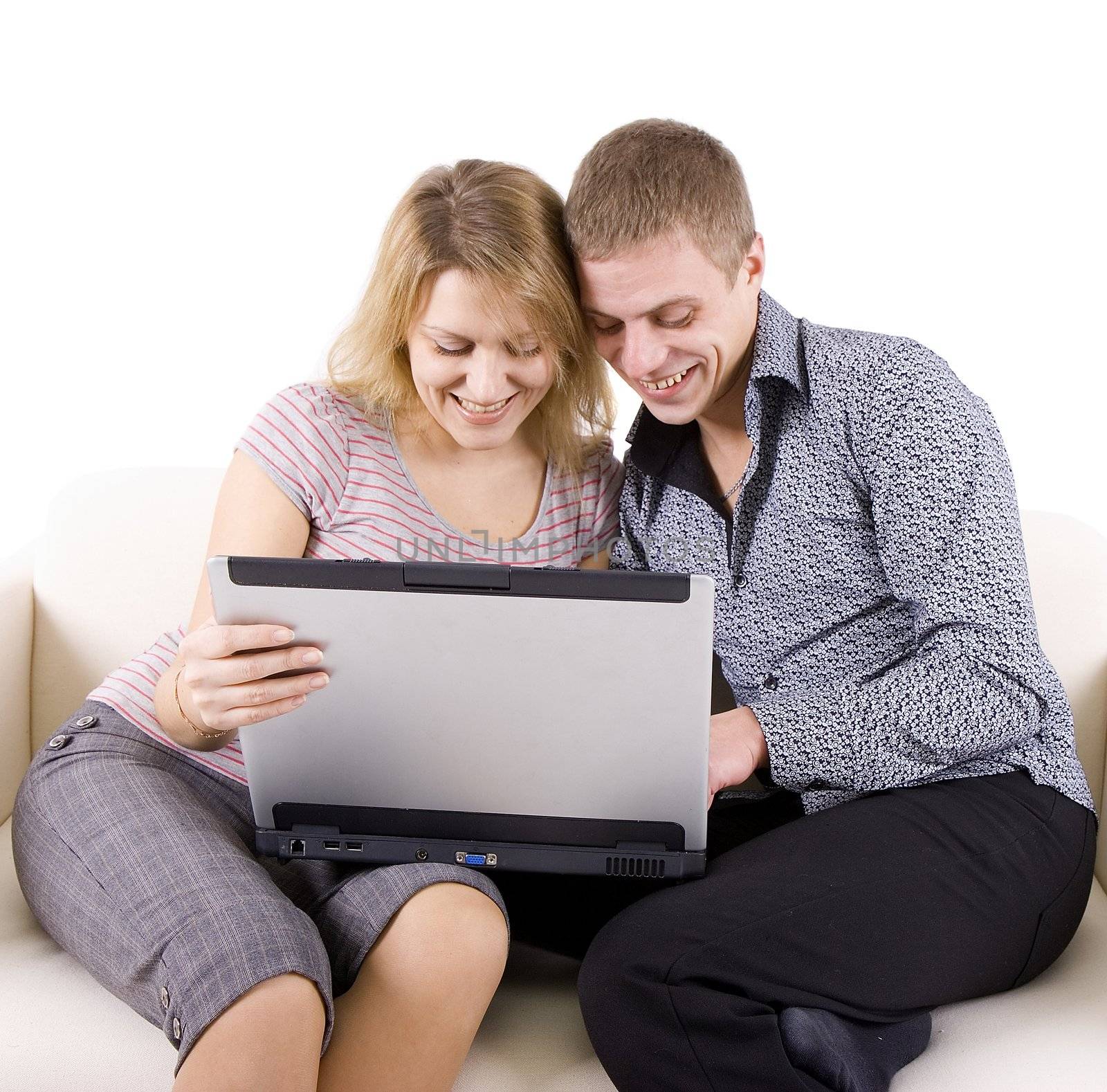 Happy man and the woman with the laptop sit on sofa