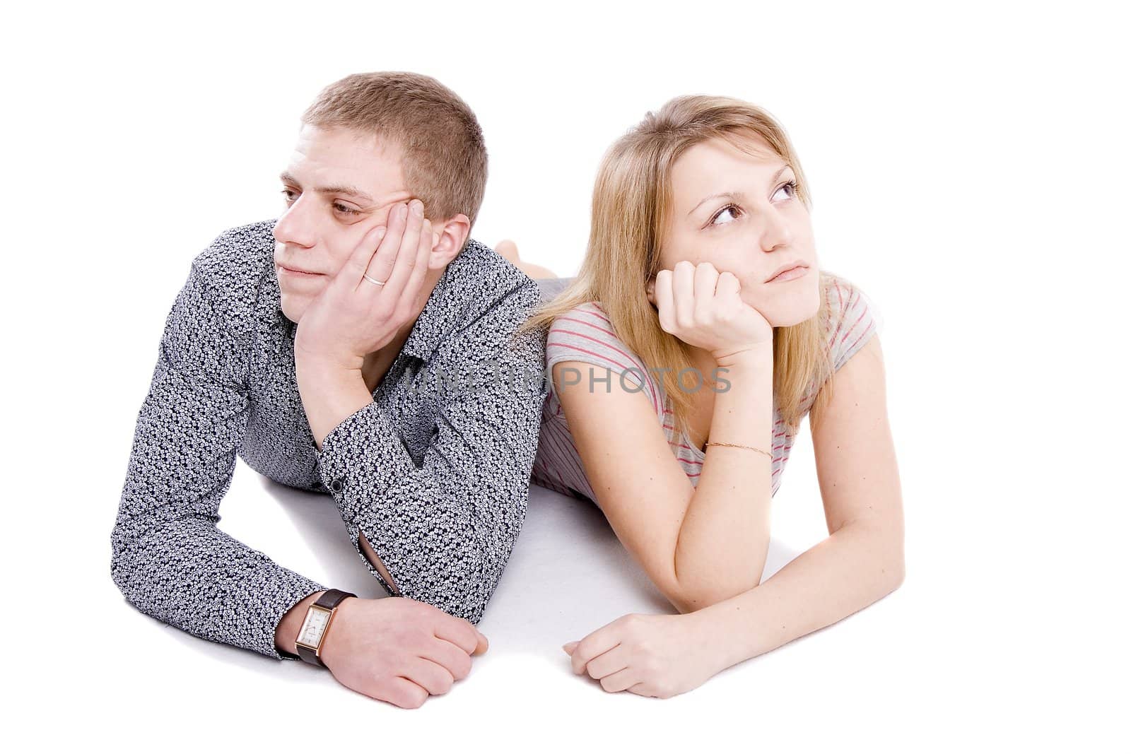 The man and the woman lie on floor on white background