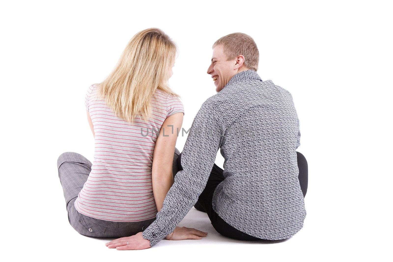 Two young men sit on white background back to the chamber