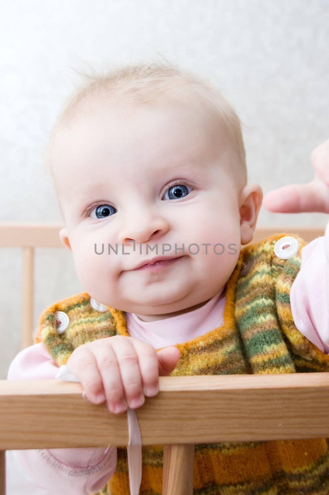 Curious baby standing in bed