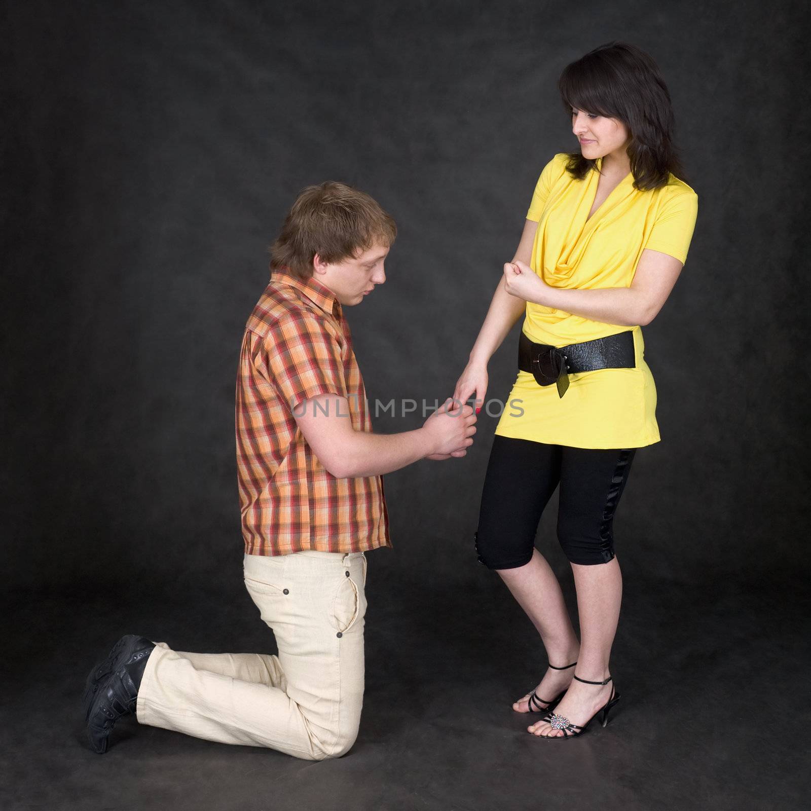 Man is kneeling to the young woman, being sorry by pzaxe