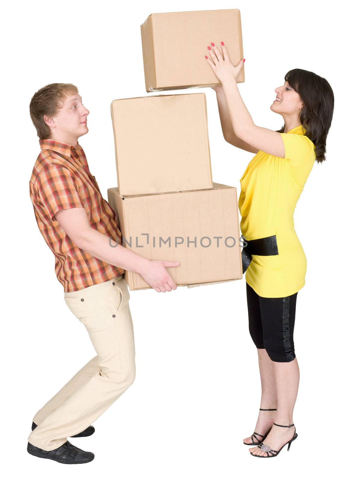 Girl loads the young man with cardboard boxes