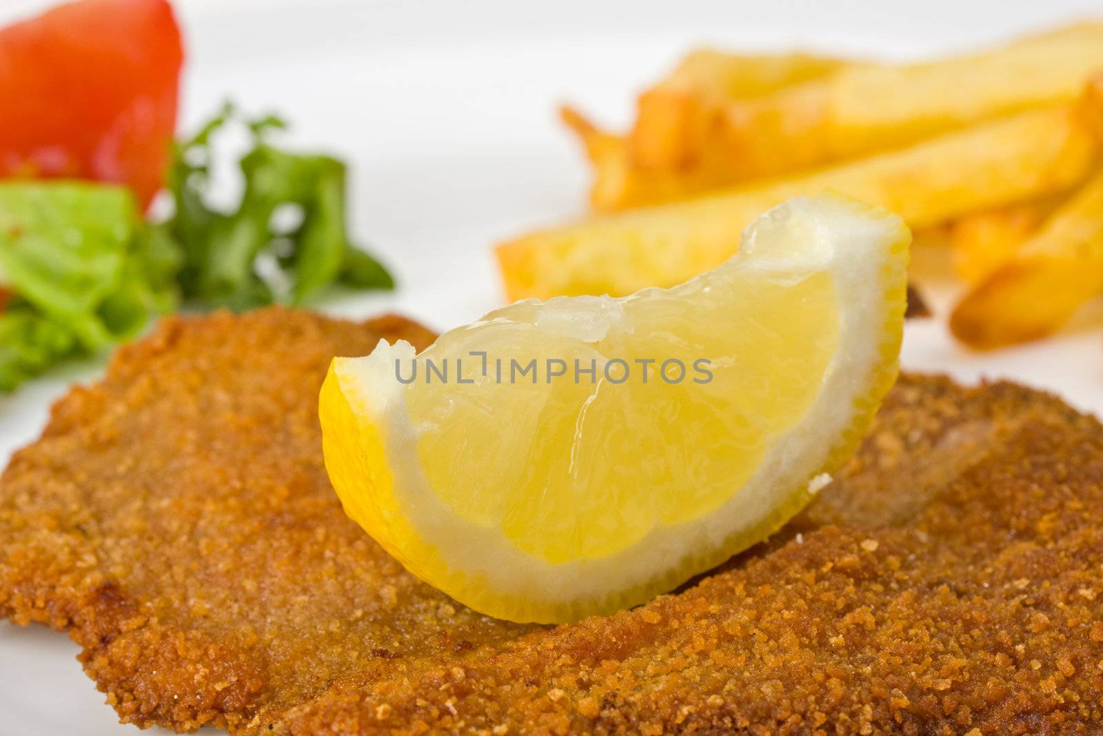 detail of a viennese schnitzel on a plate by bernjuer