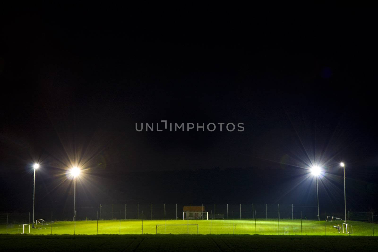 empty soccer pitch illuminated at night