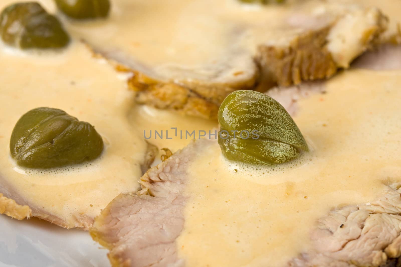 detail of vitello tonnato on a plate by bernjuer