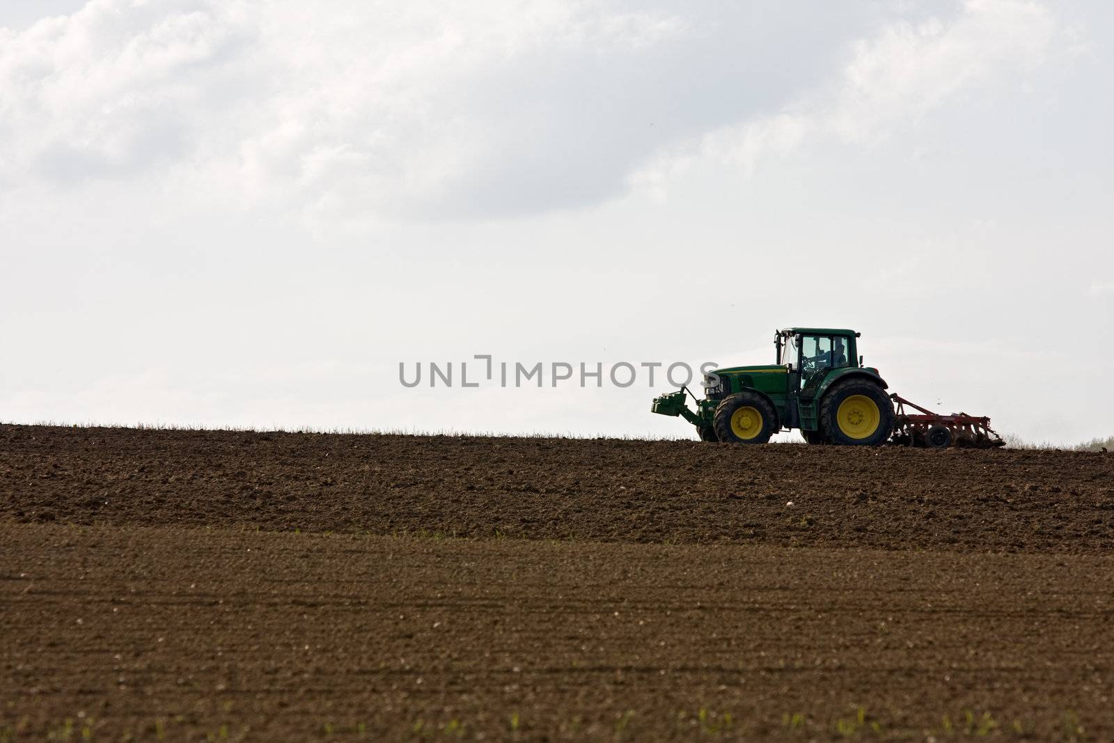 silhouette of a tractor on farmland