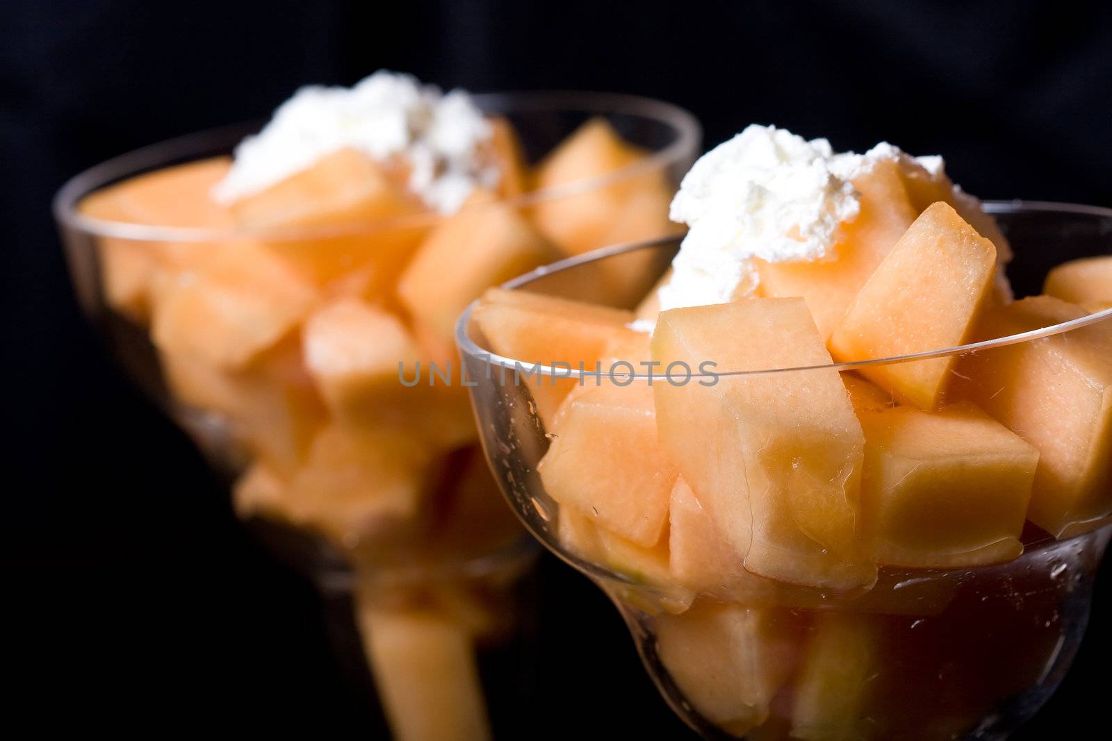 cantaloupe cut and in parfait glass dark background