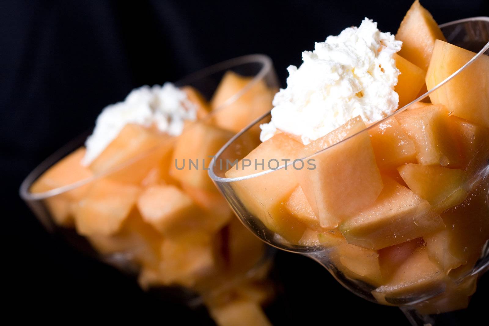 cantaloupe cut and in parfait glass dark background