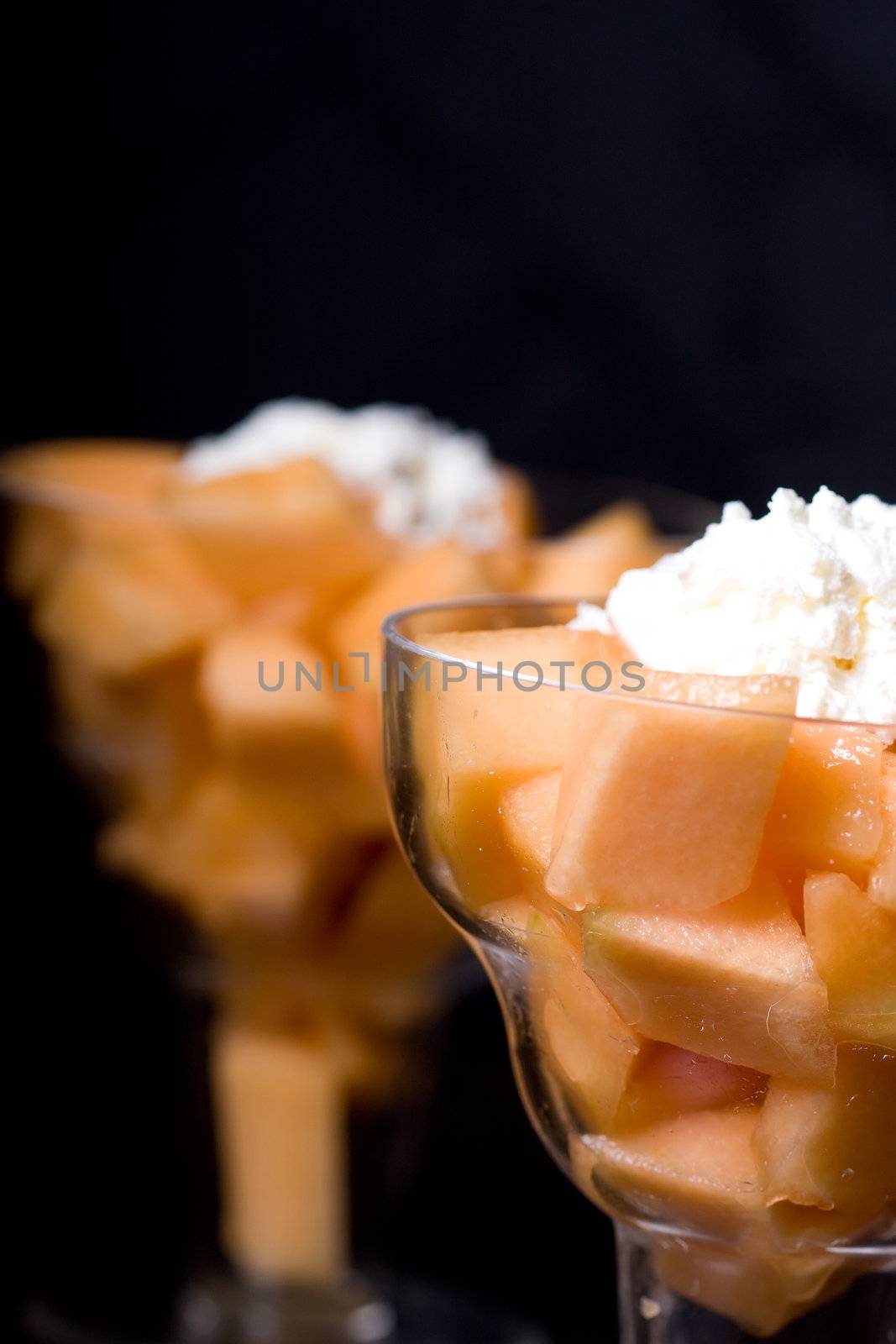 cantaloupe cut and in parfait glass dark background