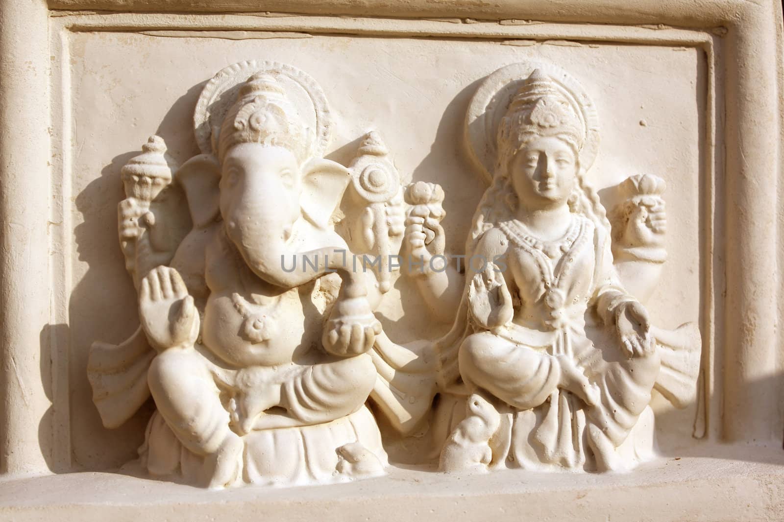 A background of a clay art of hindu god Ganesha(The Elephant God) and Goddess Laxmi (Goddess of wealth).
