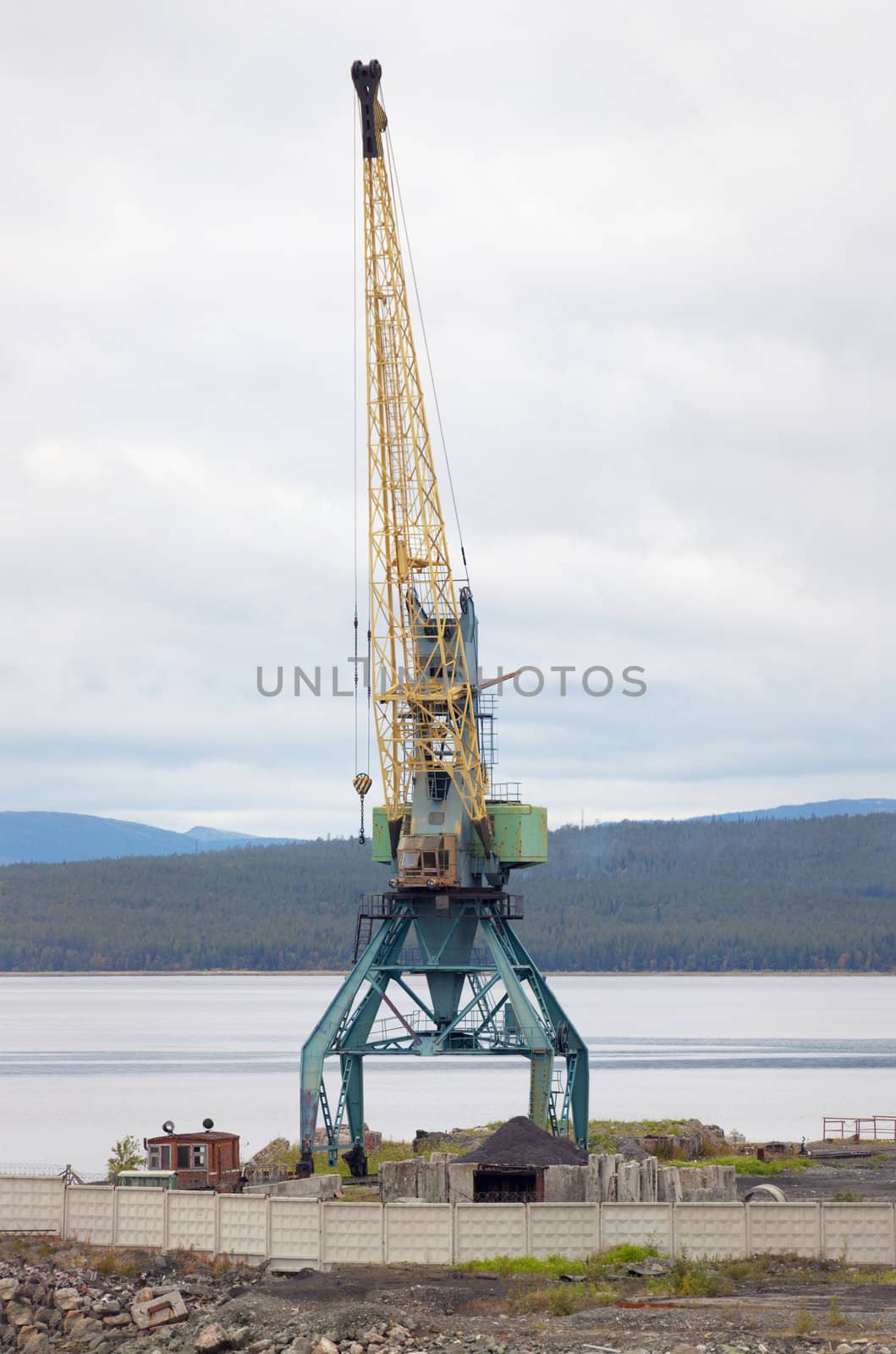 Big steel port crane on the beach