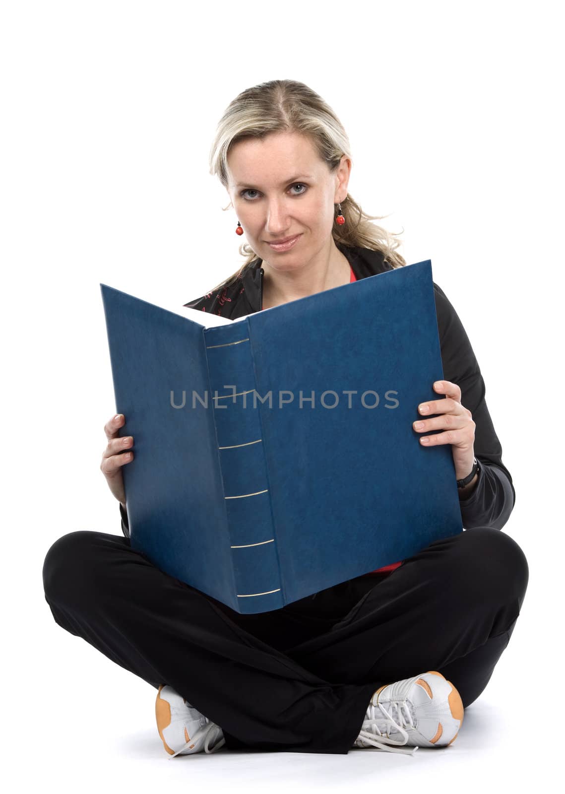 Young women with book sitt on the floor. White background