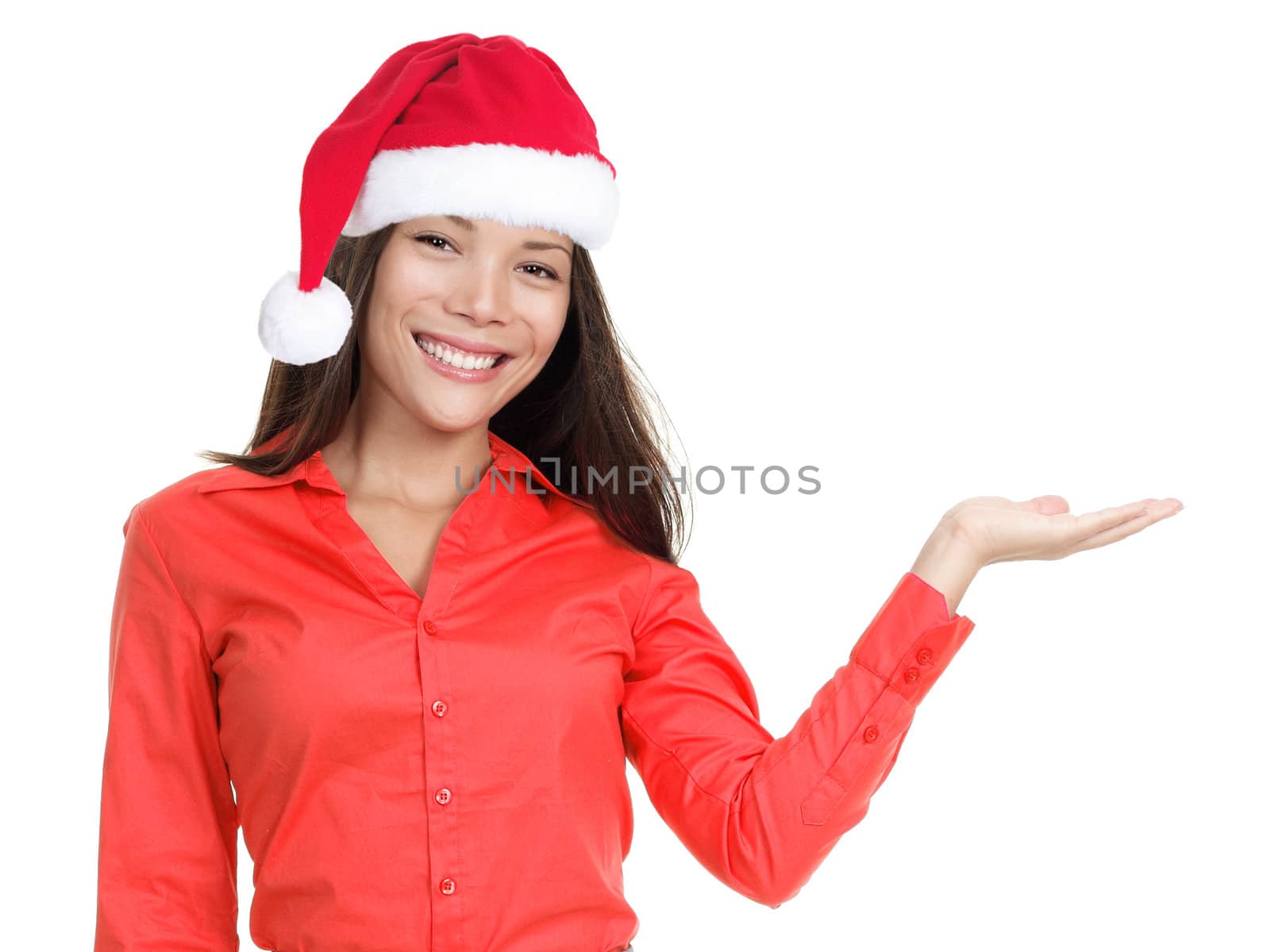 Smiling woman in christmas hat / santa hat showing open hand palm. Isolated on white background.