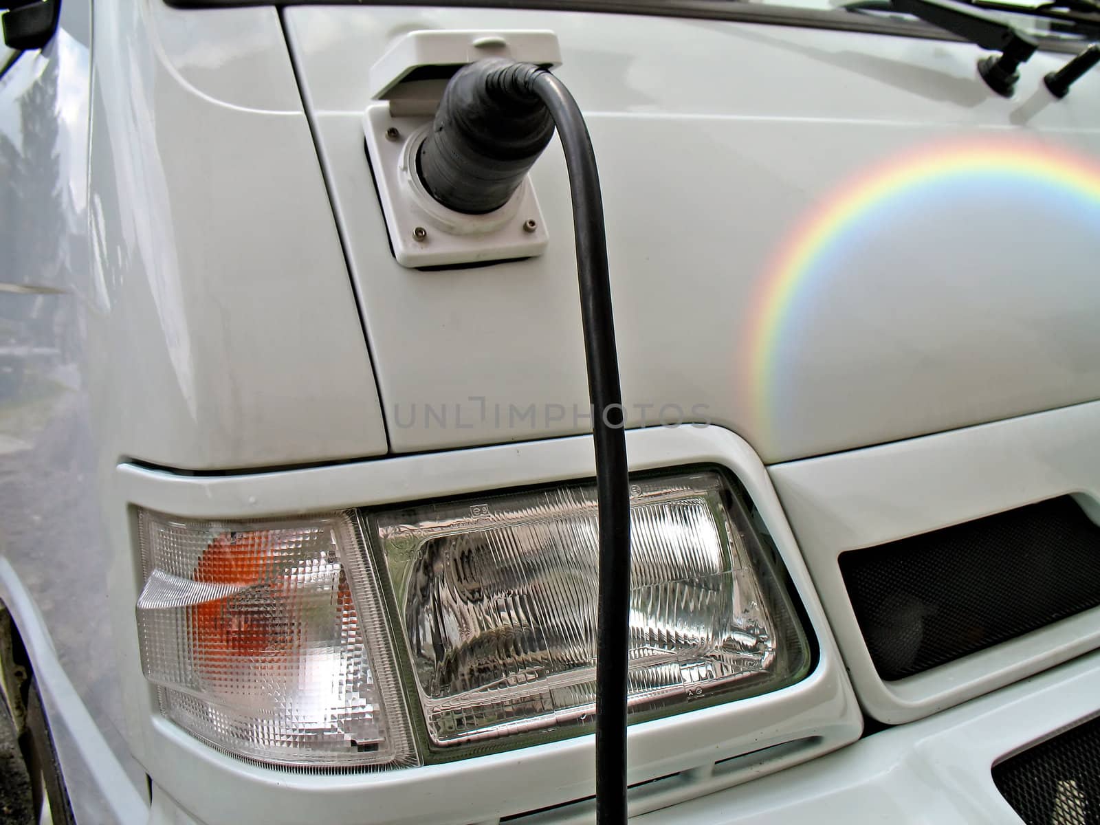 Ecologic electric car in a high mountain village. Charging operation