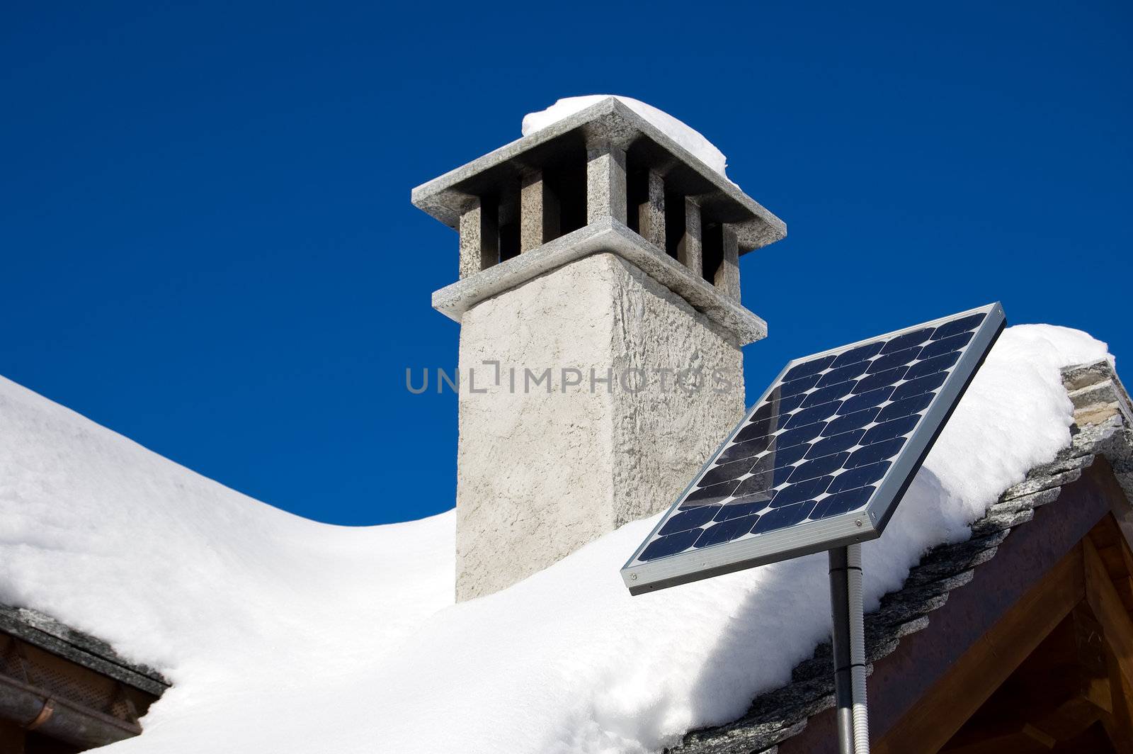 A small solar panel installed on a mountain house roof 