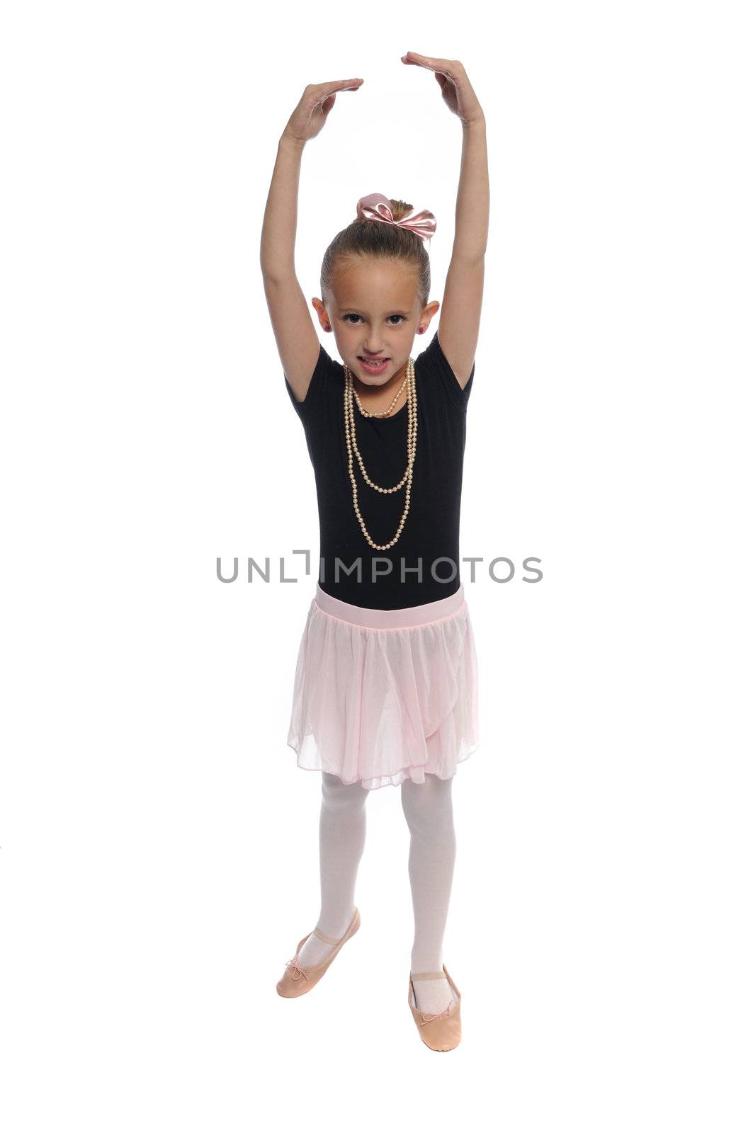 cute young girl posing in a dance costume on a white background