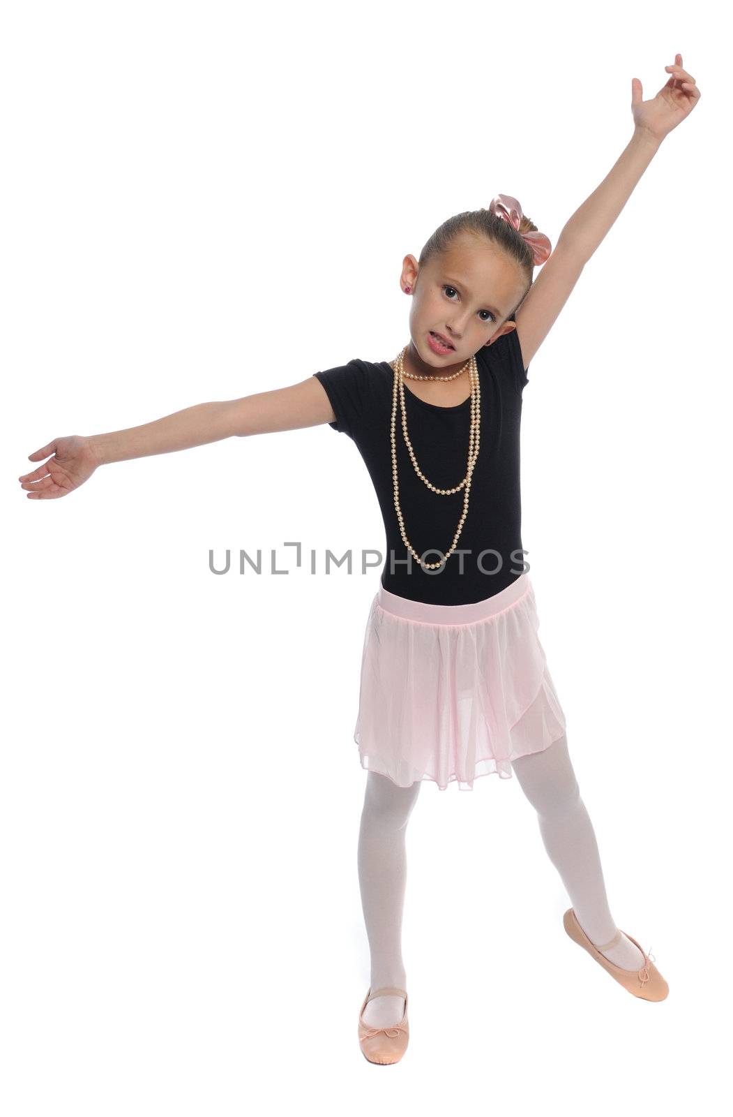 cute young girl posing in a dance costume on a white background