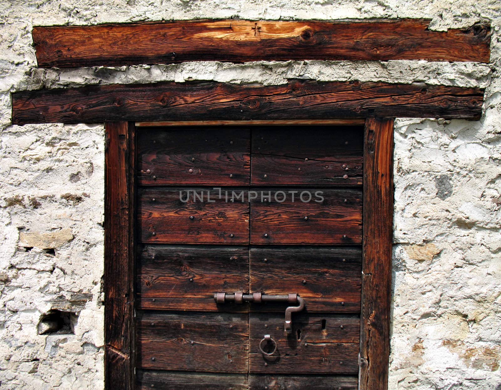 Old door of a baita (Alpine refuge) in Ossola Valley, Piedmont, Italy