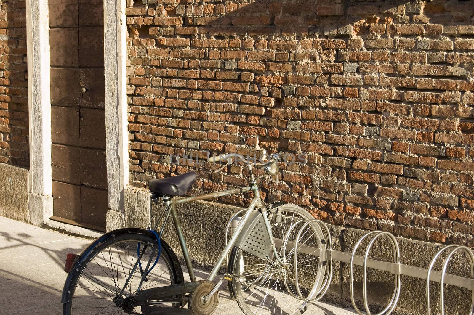 A bike parked near a red brick wall