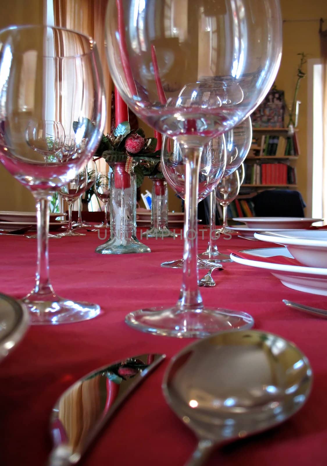 dinner setting for a party: cups of wine, cutlery, candles