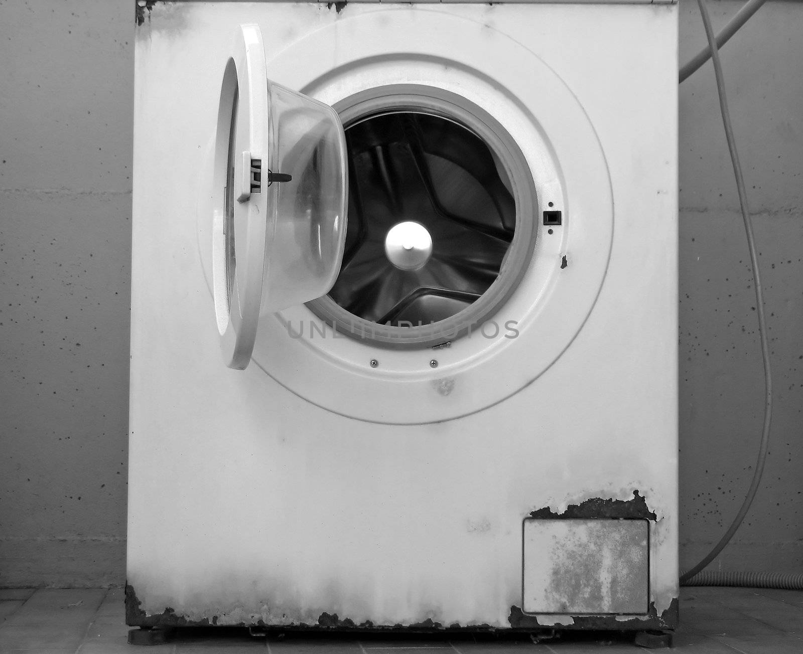 time to change your washing machine: an old rusty washing machine (B&W version)