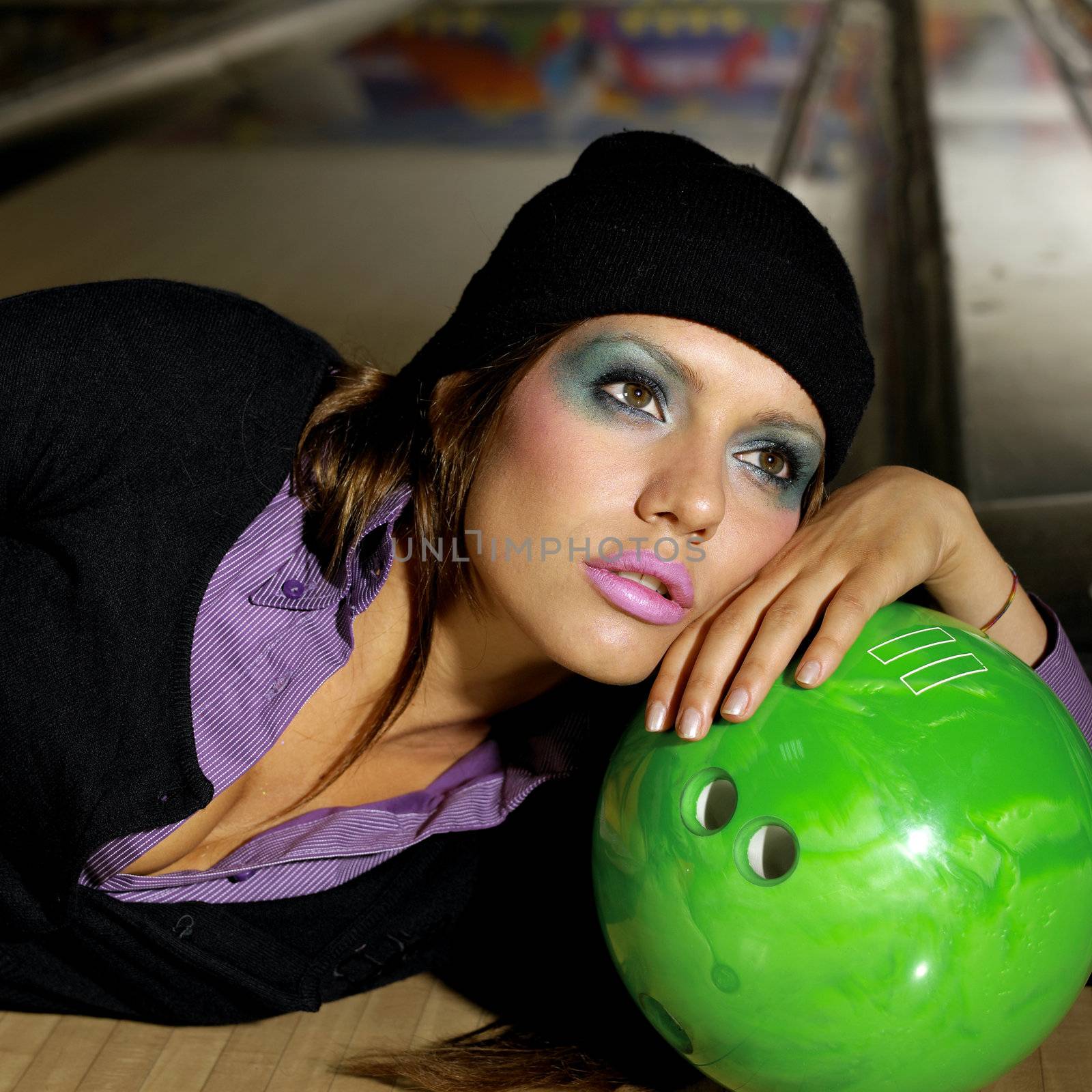 Young beautiful woman is lying in a bowling